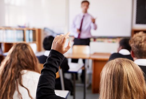 Female,Student,Raising,Hand,To,Ask,Question,In,Classroom